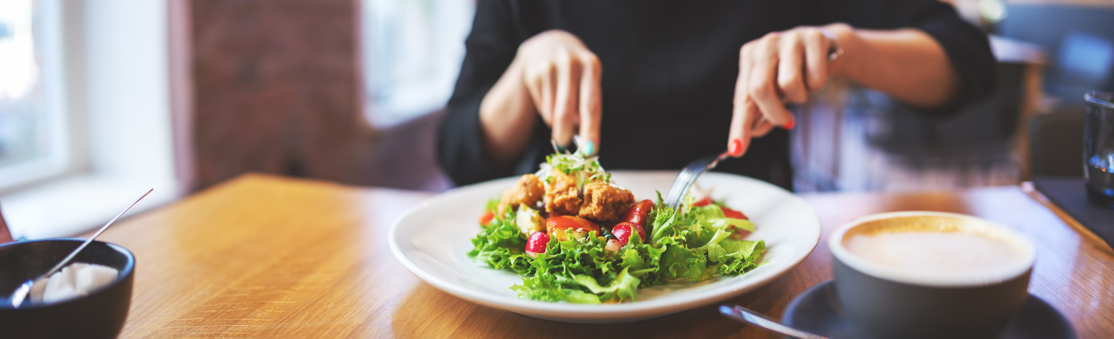 Woman eating a salad indoors