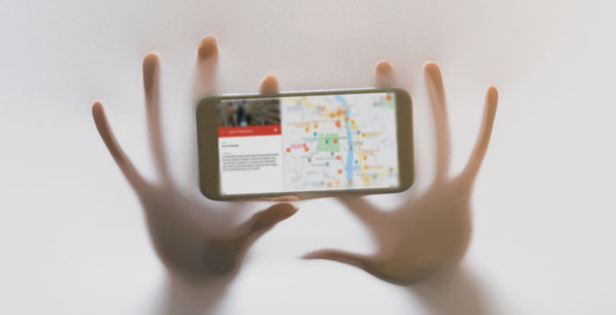 Blurred hands holding a phone with a map displayed